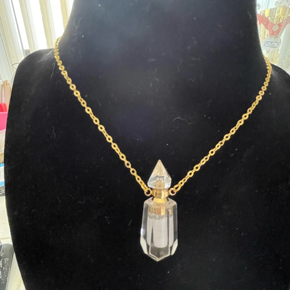 Stunning perfume necklace with attached chain.